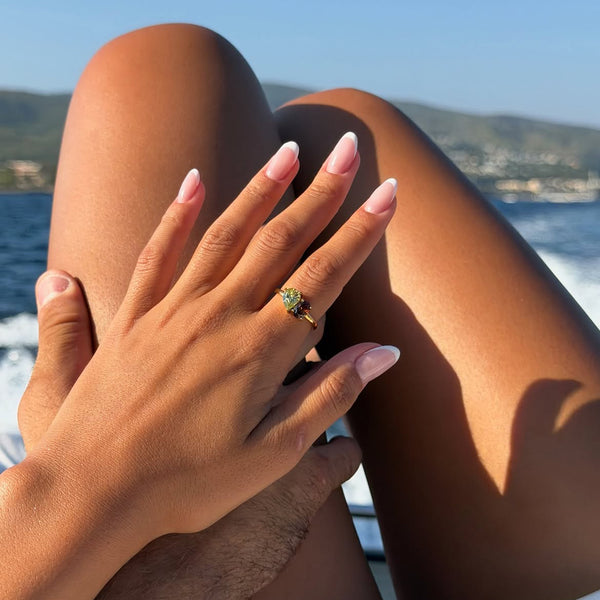 Ring with a green stone, worn on a boat by the sea